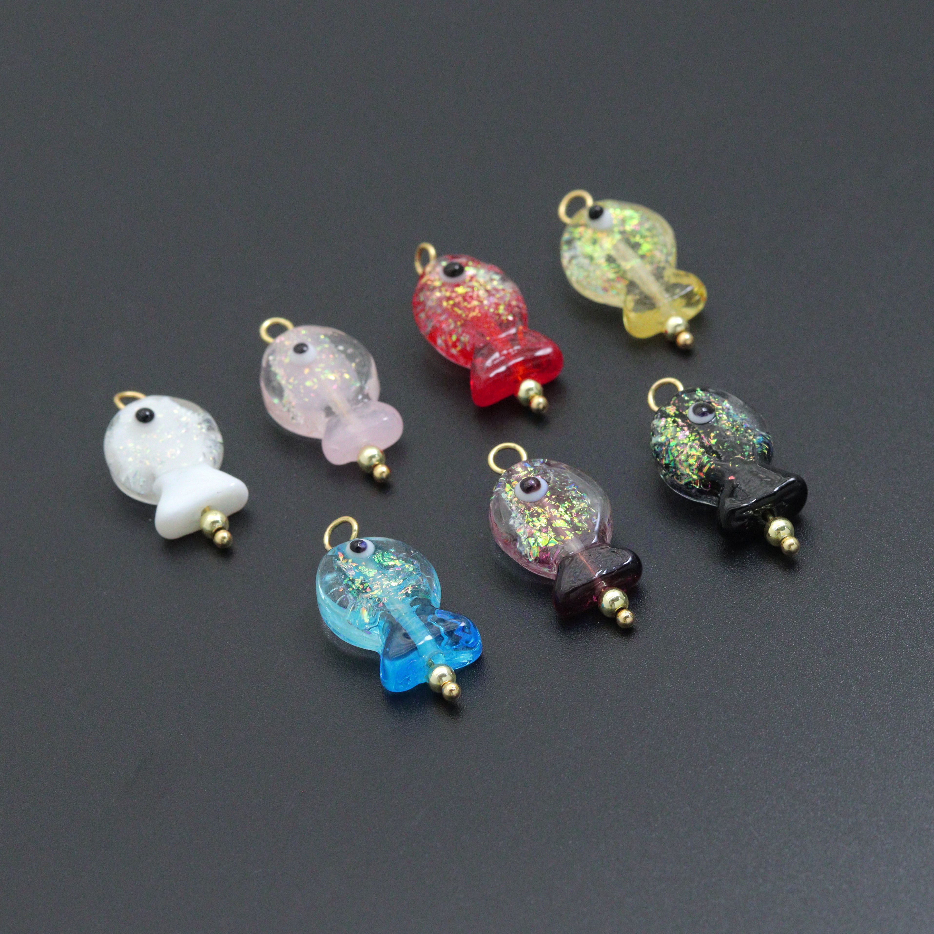 Handmade colorful glitter fish charm with evil eye design, crafted by Bestbeads&Beyond, featuring vibrant details and a lucky symbol.