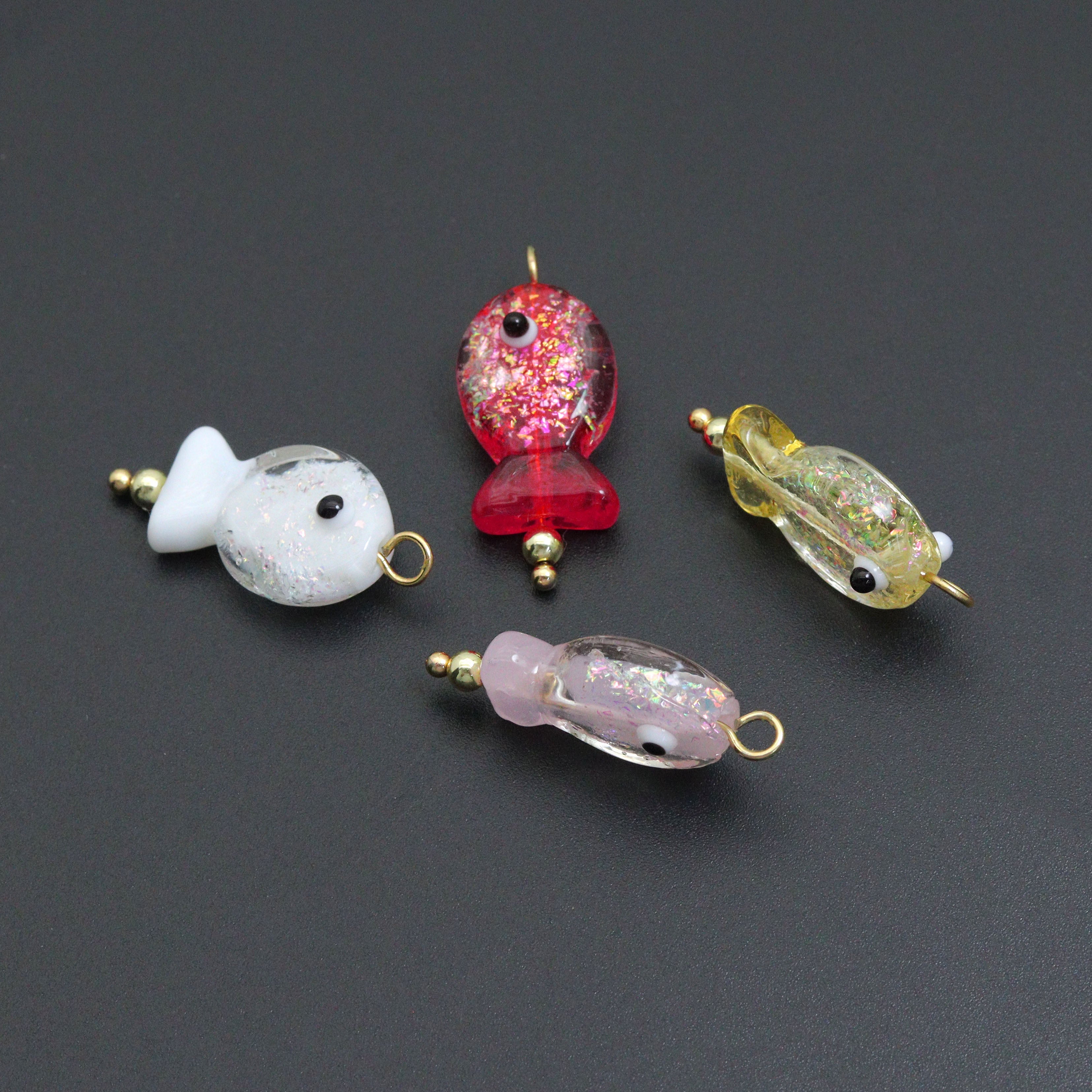 Handmade colorful glitter fish charm with evil eye design, crafted by Bestbeads&Beyond, featuring vibrant hues and intricate details.