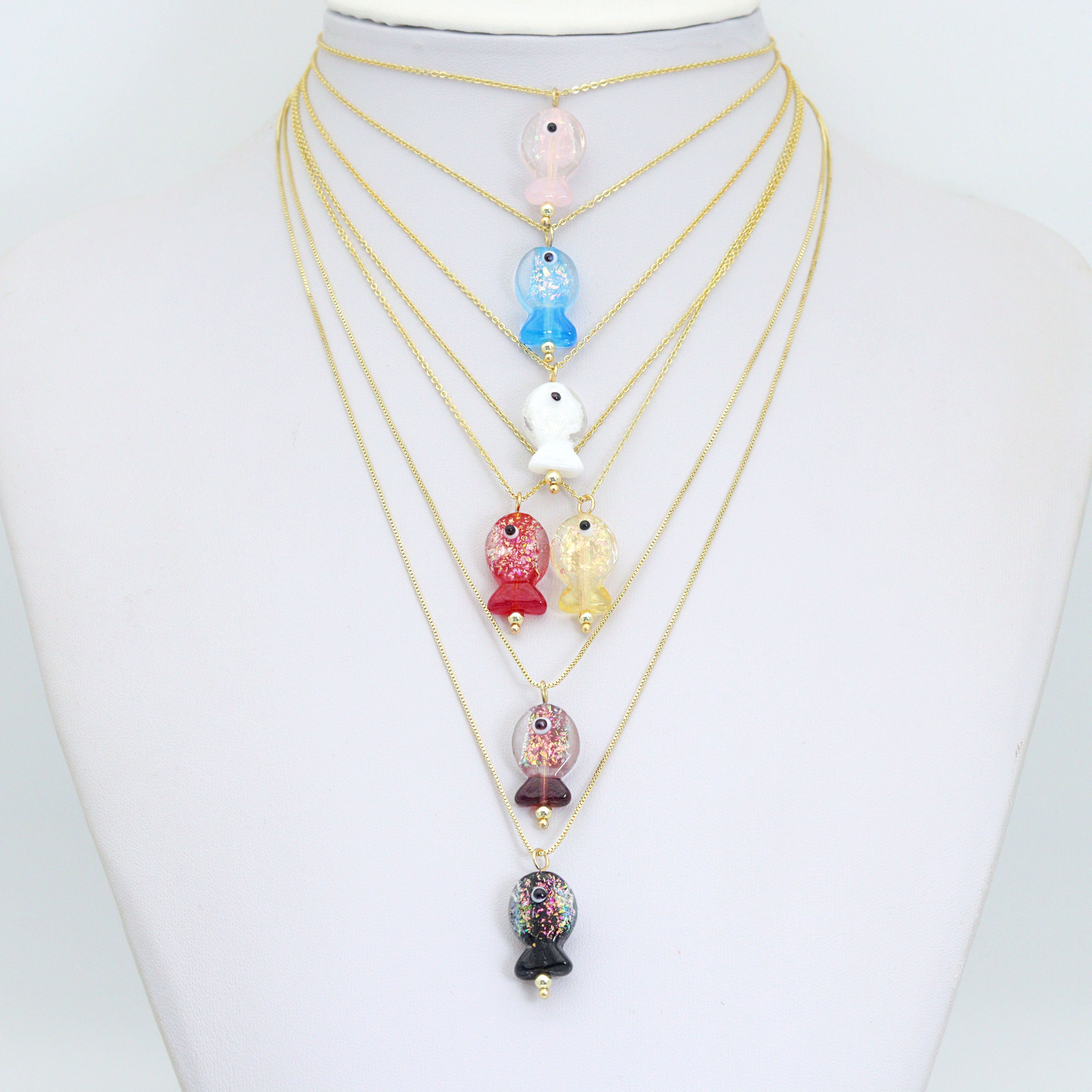 Handmade colorful glitter fish charm with evil eye design, crafted by Bestbeads&Beyond, featuring vibrant details and a lucky charm appearance.