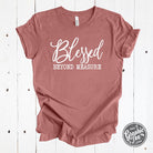 Heather mauve Blessed Beyond Measure graphic tee by The Graphic Tee, showcasing a stylish short-sleeve design with inspirational text.