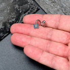 Blue Gem Baroque Butterfly Spiral Belly Ring by BodyCandy featuring a twisted spiral design with a decorative blue gemstone.