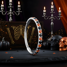 Black and orange 20G Micro Gem titanium hinged segment ring nose hoop by BodyCandy, featuring a sleek design and secure clasp.