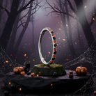 Black and orange 20G micro gem titanium hinged segment ring nose hoop, BodyCandy brand, with a sleek, curved design.