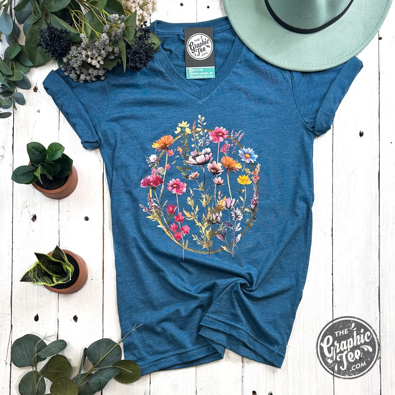 Boho floral ring design short sleeve V-neck graphic tee by The Graphic Tee, displaying vibrant floral print and casual fit.