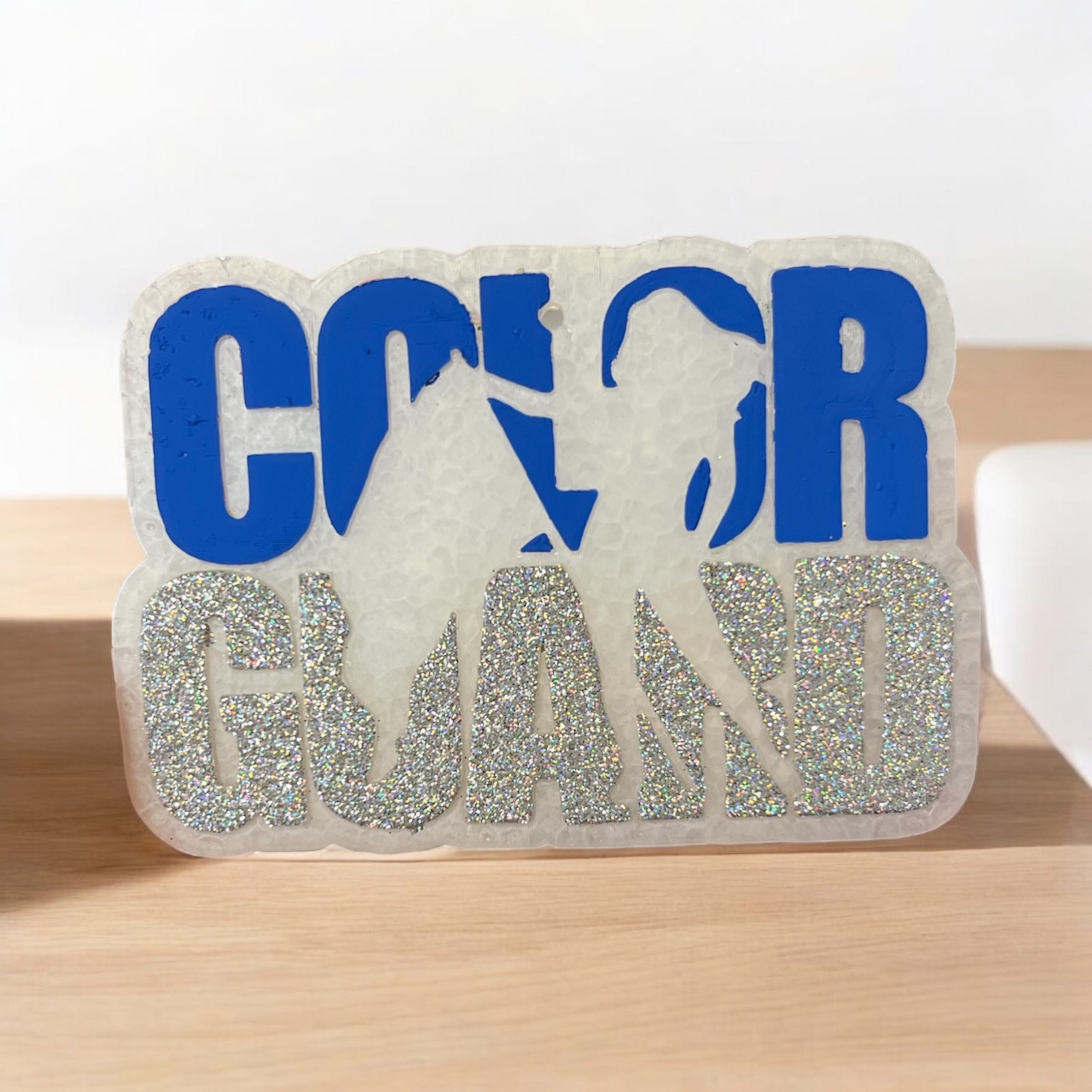 Color Guard Freshie air freshener by Bug & Bean Freshies in vibrant colors, hanging with a decorative ribbon.