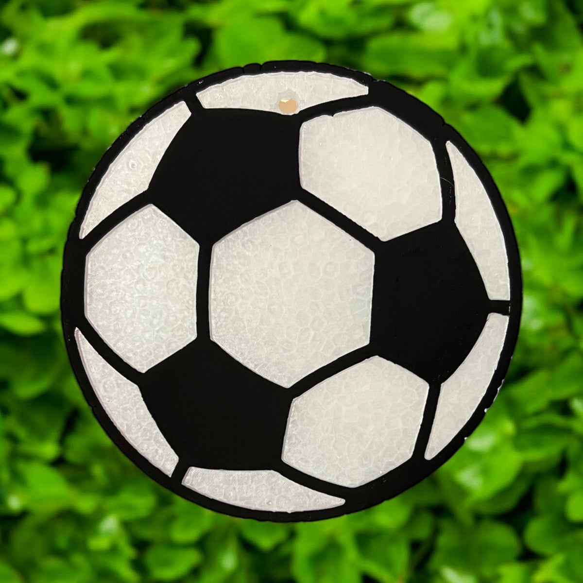 Soccer ball-shaped Freshie air freshener from Bug & Bean Freshies, with bright green and white panels and a textured surface.