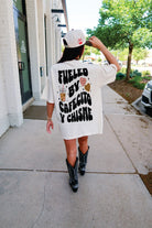 Model wearing a Cafecito y Chisme t-shirt by Shop Karma Tees, showcasing the vibrant design on the front.