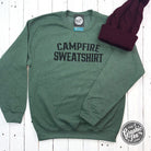 Heather dark green crewneck sweatshirt with campfire graphic, from The Graphic Tee, perfect for casual wear and outdoor adventures.