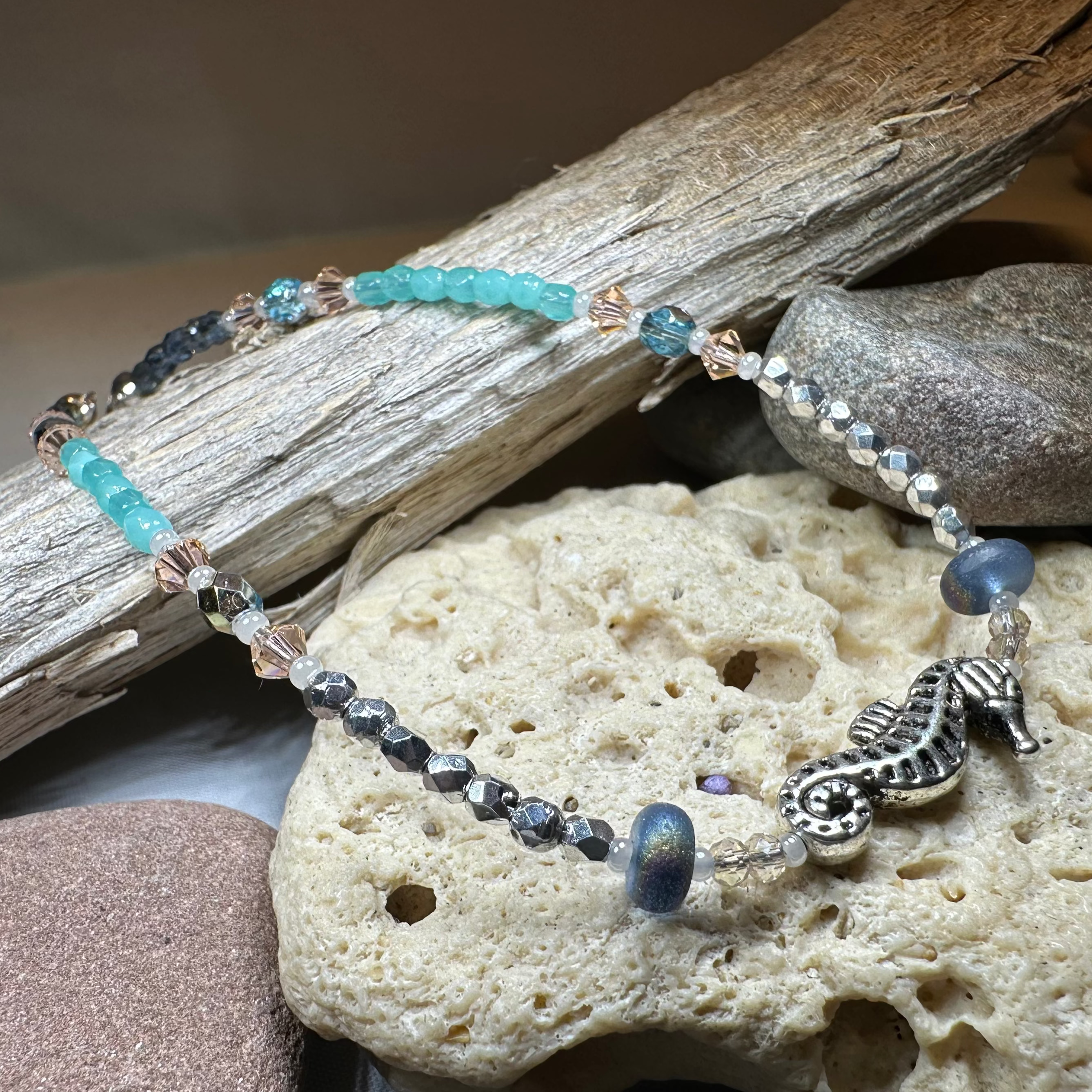 Beachy Seahorse ankle bracelet by Celtic Crystal Design Jewelry featuring green and pink seahorse charms on a delicate bracelet.