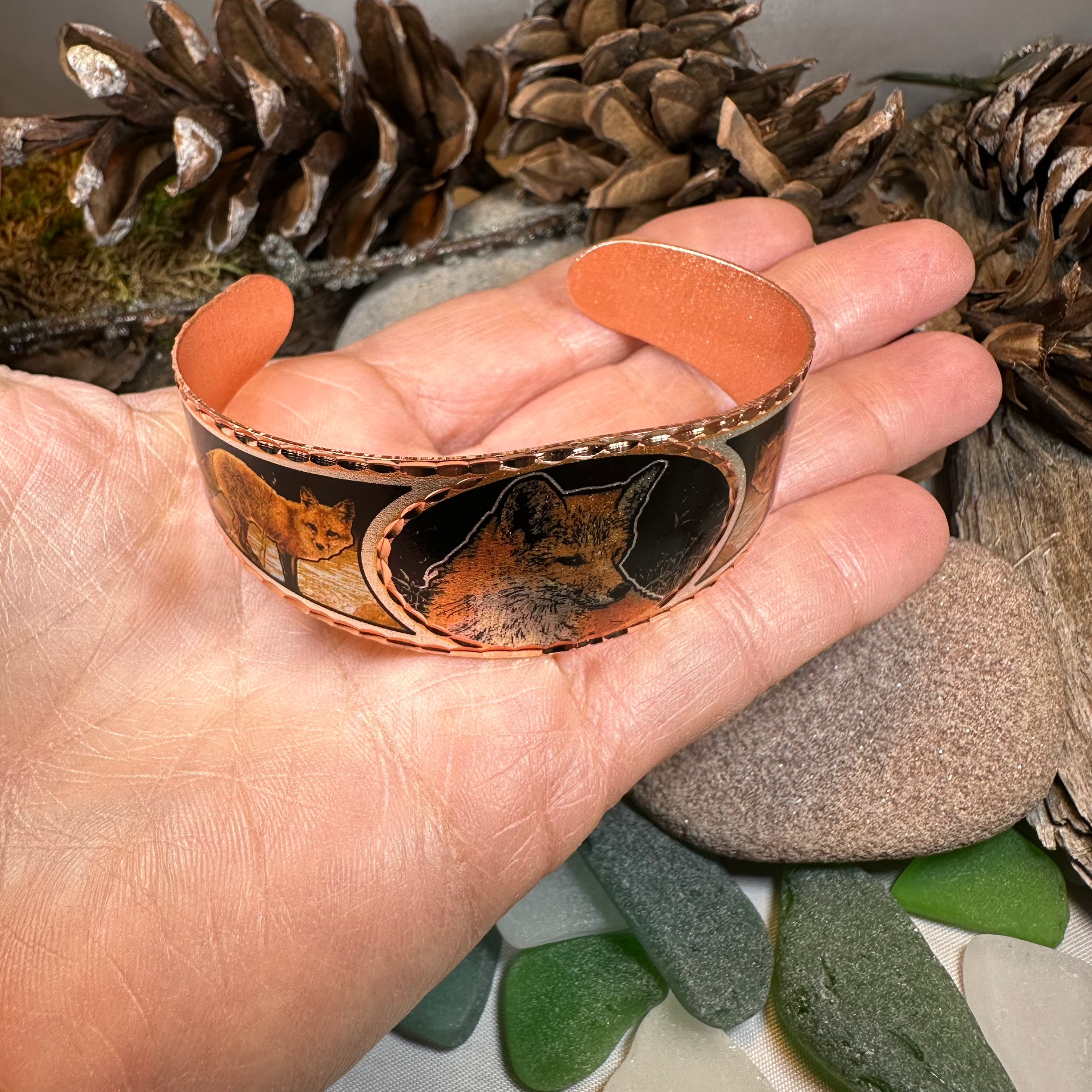Fox Spirit Copper Cuff Bracelet from Celtic Crystal Design Jewelry featuring intricate Celtic patterns on a polished copper bracelet.