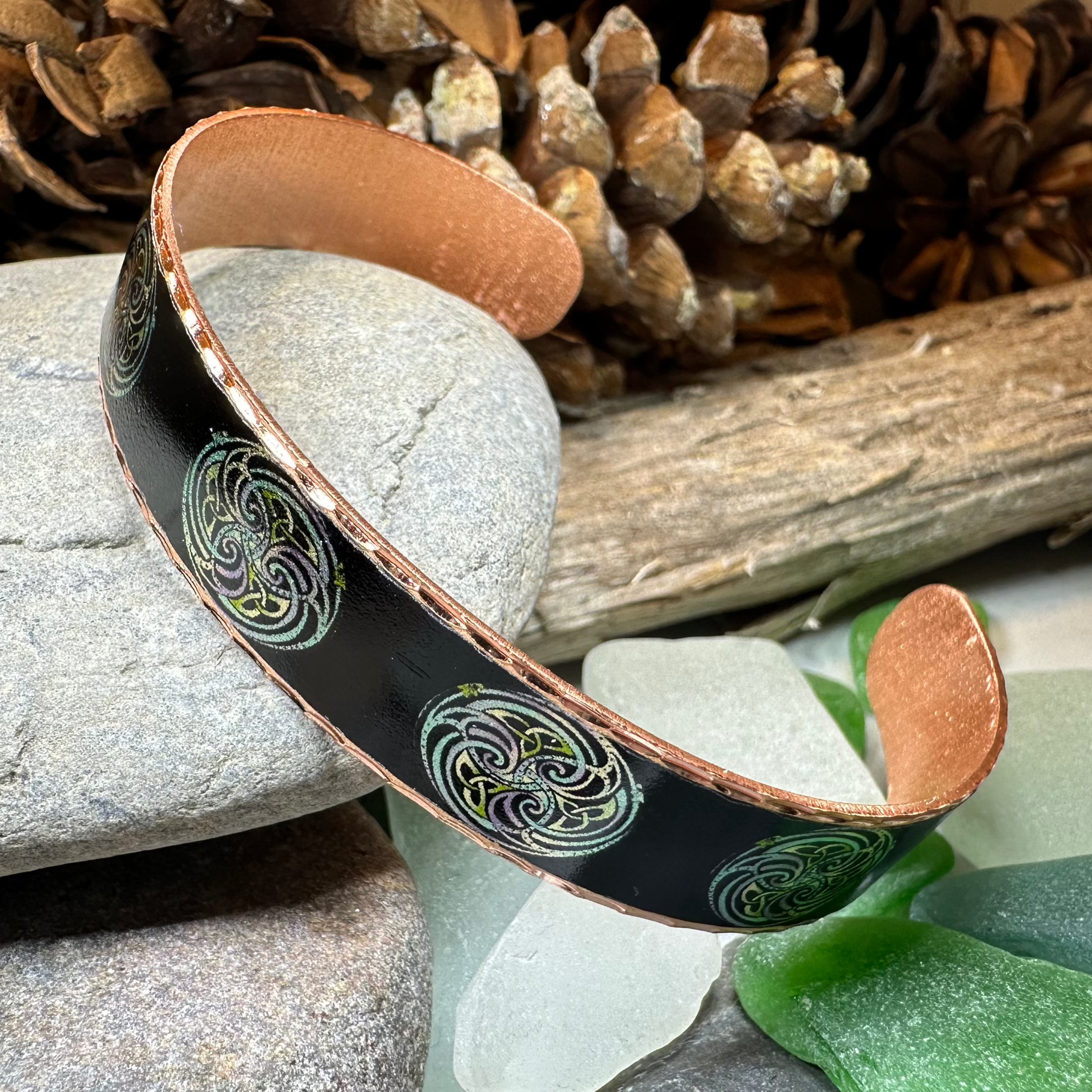 Mystical Celtic Spiral Copper Cuff Bracelet by Celtic Crystal Design Jewelry featuring intricate Celtic knot patterns and spiral motifs.