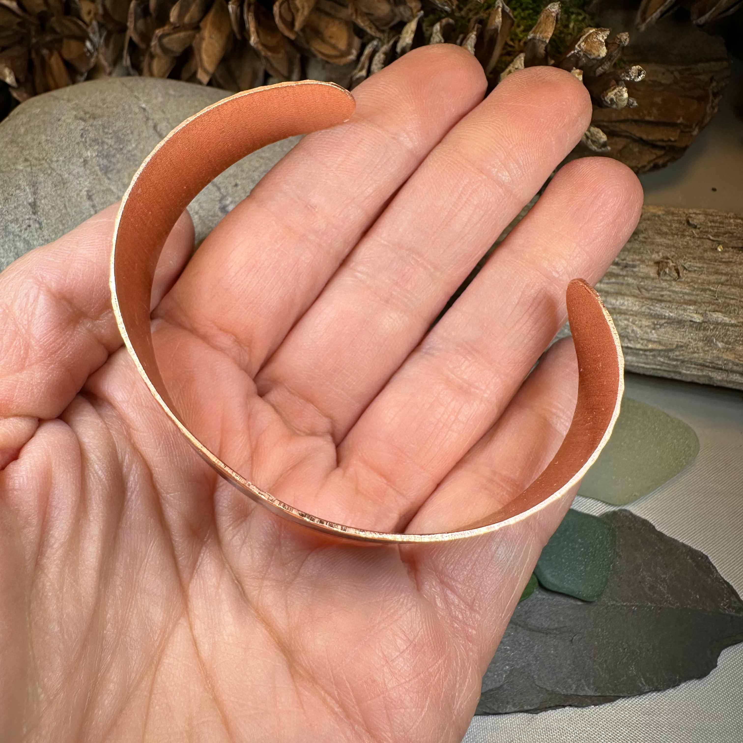 Mystical Owl copper cuff bracelet by Celtic Crystal Design Jewelry featuring an intricate owl design on a polished copper band.