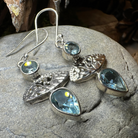 Celtic Morning Blue Topaz Dangle Earrings from Celtic Crystal Design Jewelry with intricate silver Celtic motifs and vibrant blue topaz.