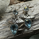 Celtic Morning Blue Topaz Dangle Earrings featuring intricate Celtic design and sparkling blue topaz gemstones.