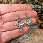 Celtic Morning Blue Topaz Dangle Earrings by Celtic Crystal Design Jewelry featuring sparkling blue topaz gemstones and intricate Celtic patterns.