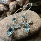 Celtic Morning Blue Topaz Dangle Earrings by Celtic Crystal Design Jewelry, featuring sparkling blue topaz stones and intricate Celtic patterns.