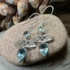 Celtic Morning Blue Topaz Dangle Earrings with intricate Celtic design silver settings, showcasing vibrant blue topaz stones.