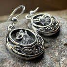 Celtic Wolf Spirit dangle earrings by Celtic Crystal Design Jewelry featuring intricate Celtic knot and wolf motif in silver tone.