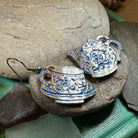Celtic Crystal Design Jewelry old-fashioned teapot and cup dangle earrings with intricate details on silver-toned metal.