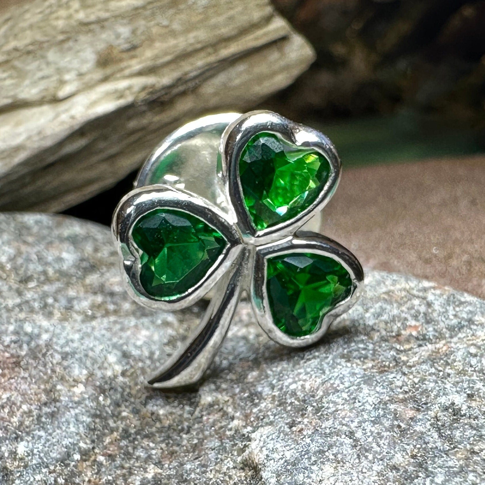 Irish emerald shamrock lapel pin by Celtic Crystal Design Jewelry, featuring a detailed green shamrock design on a metal lapel pin.