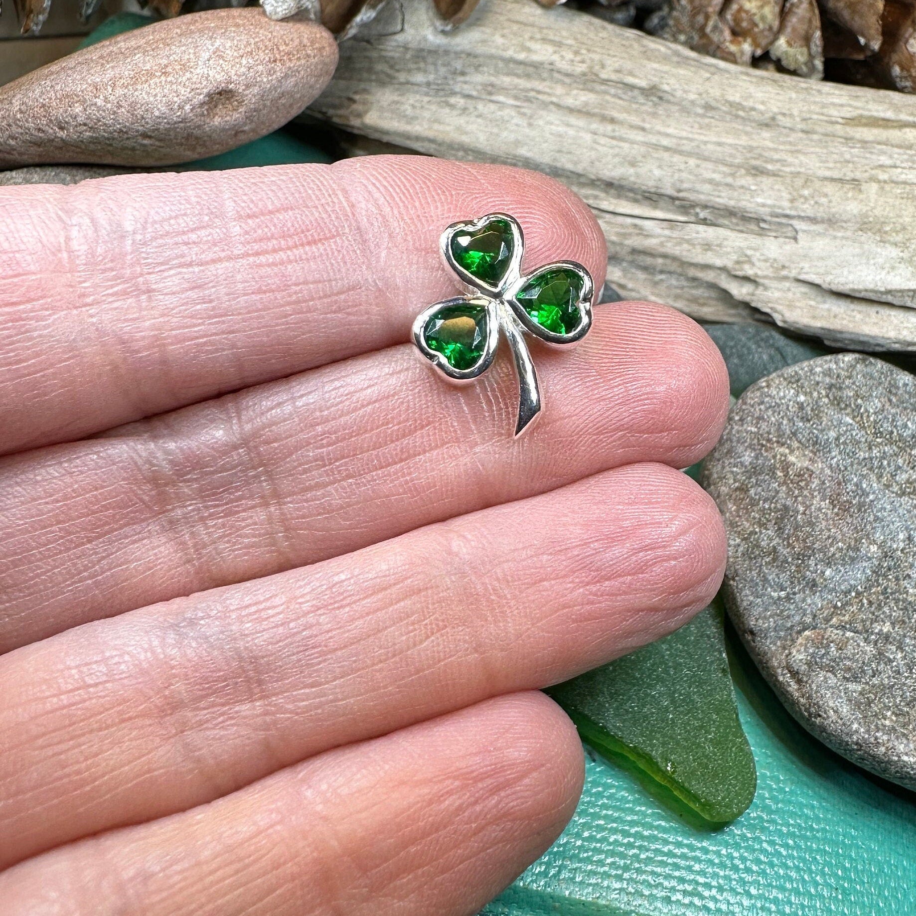 Irish Emerald Shamrock lapel pin by Celtic Crystal Design Jewelry featuring a detailed emerald shamrock design on a metal pin.