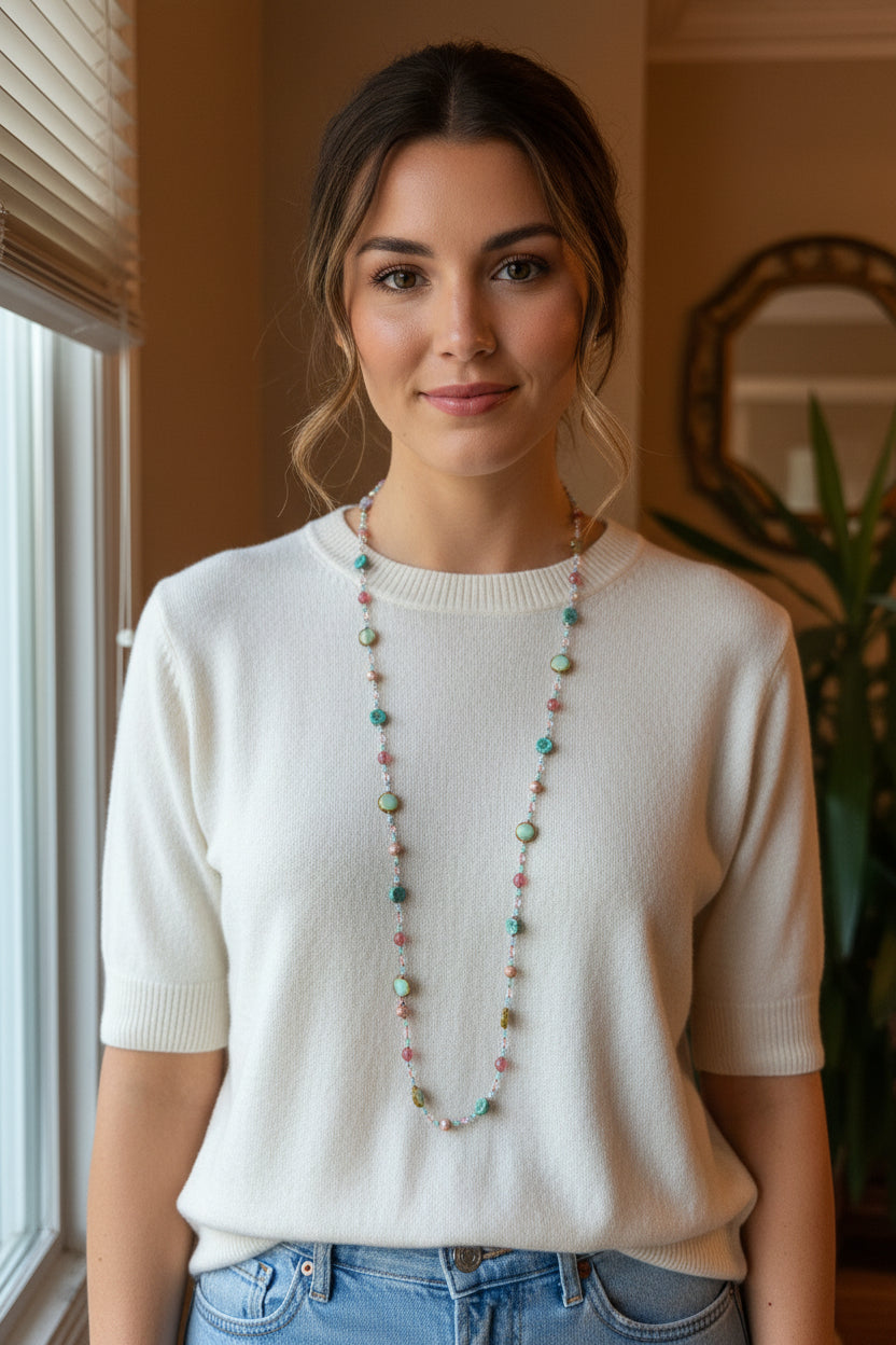 Pink Beach Blossom long necklace by Celtic Crystal Design Jewelry, featuring a delicate pink floral pendant on a long chain.