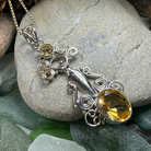 Celtic Crystal Design Jewelry Rising Goddess pendant necklace with oval citrine gemstone, intricate Celtic knot details.