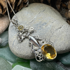 Celtic Crystal Design Jewelry Rising Goddess pendant necklace with oval citrine gemstone and intricate Celtic detailing.