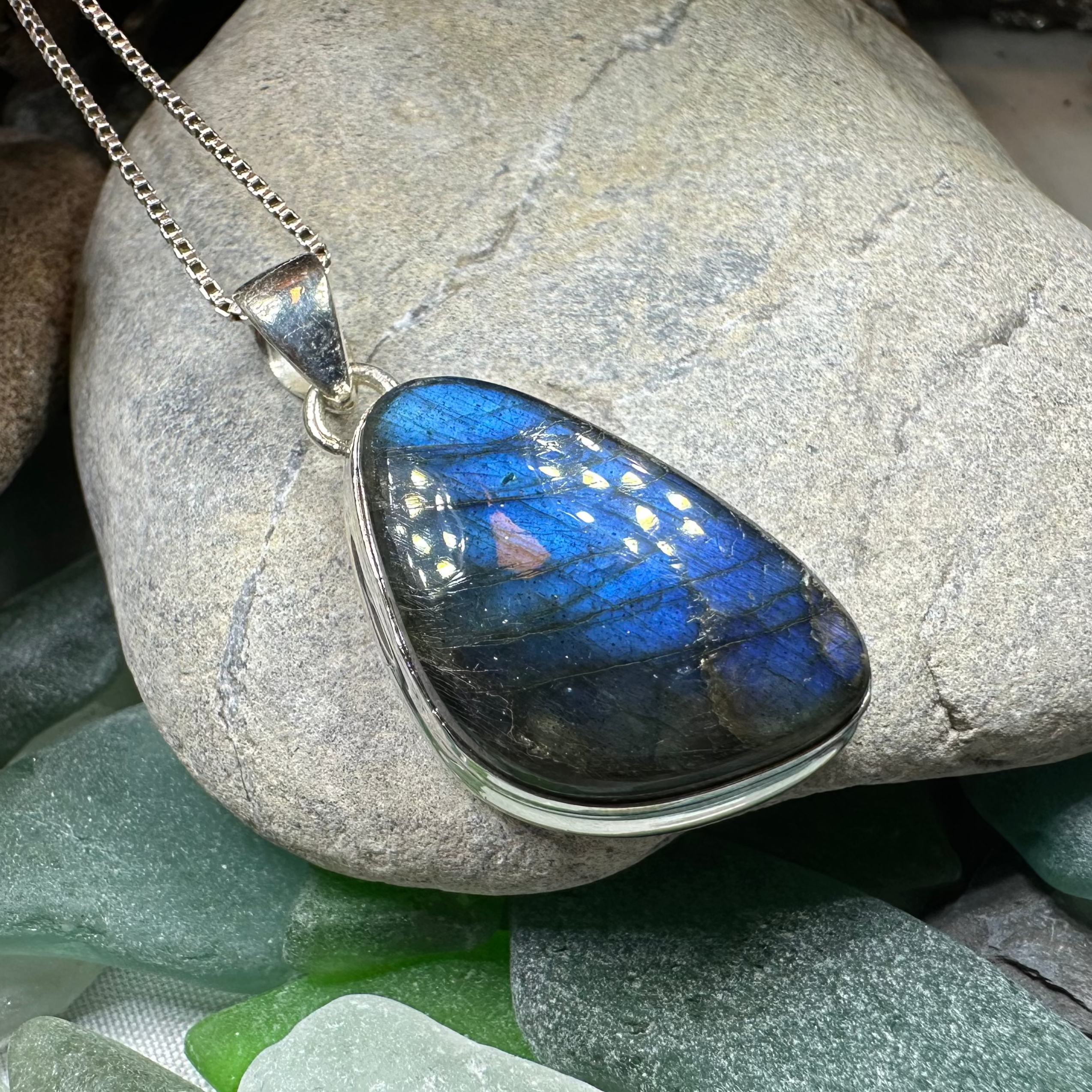 Celtic Crystal Design Jewelry Galaxy Blue Labradorite pendant necklace featuring an 18-inch chain and a large, shimmering labradorite stone.