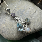 Seamist Seahorse Necklace pendant by Celtic Crystal Design Jewelry featuring topaz and amethyst gemstones in a detailed seahorse design.