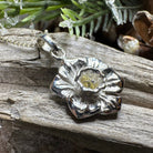 Celtic Crystal Design Jewelry Welsh Daffodil pendant necklace featuring a detailed floral charm on a silver chain.