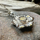 Celtic Crystal Design Jewelry Welsh Daffodil pendant necklace featuring a delicate floral charm on a silver chain.