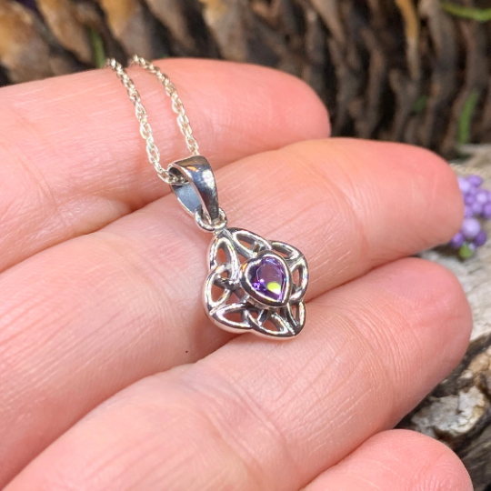 Amethyst Celtic knot pendant necklace by Celtic Crystal Design Jewelry featuring an intricate Celtic knot design and purple gemstone.