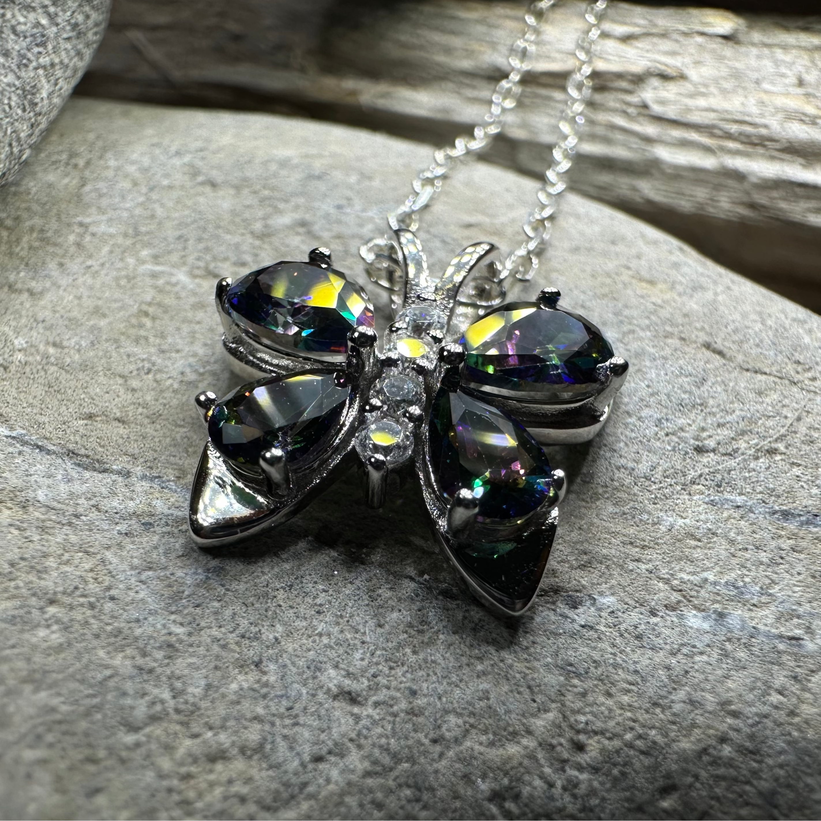 Celtic Crystal Design Jewelry Mystic Topaz butterfly pendant necklace featuring a sparkling gemstone and intricate silver detailing.