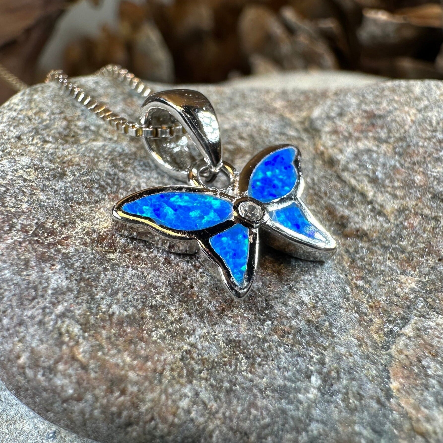 Pink opal butterfly pendant necklace by Celtic Crystal Design Jewelry, featuring a petite butterfly-shaped gemstone pendant.