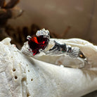 Garnet Claddagh ring by Celtic Crystal Design Jewelry featuring a heart-shaped garnet gemstone and traditional Celtic design.