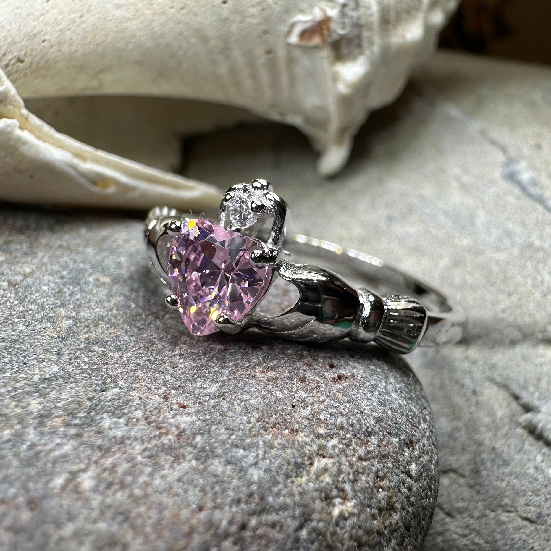 Petal pink Claddagh ring by Celtic Crystal Design Jewelry showing intricate Celtic design and light pink gemstone details.