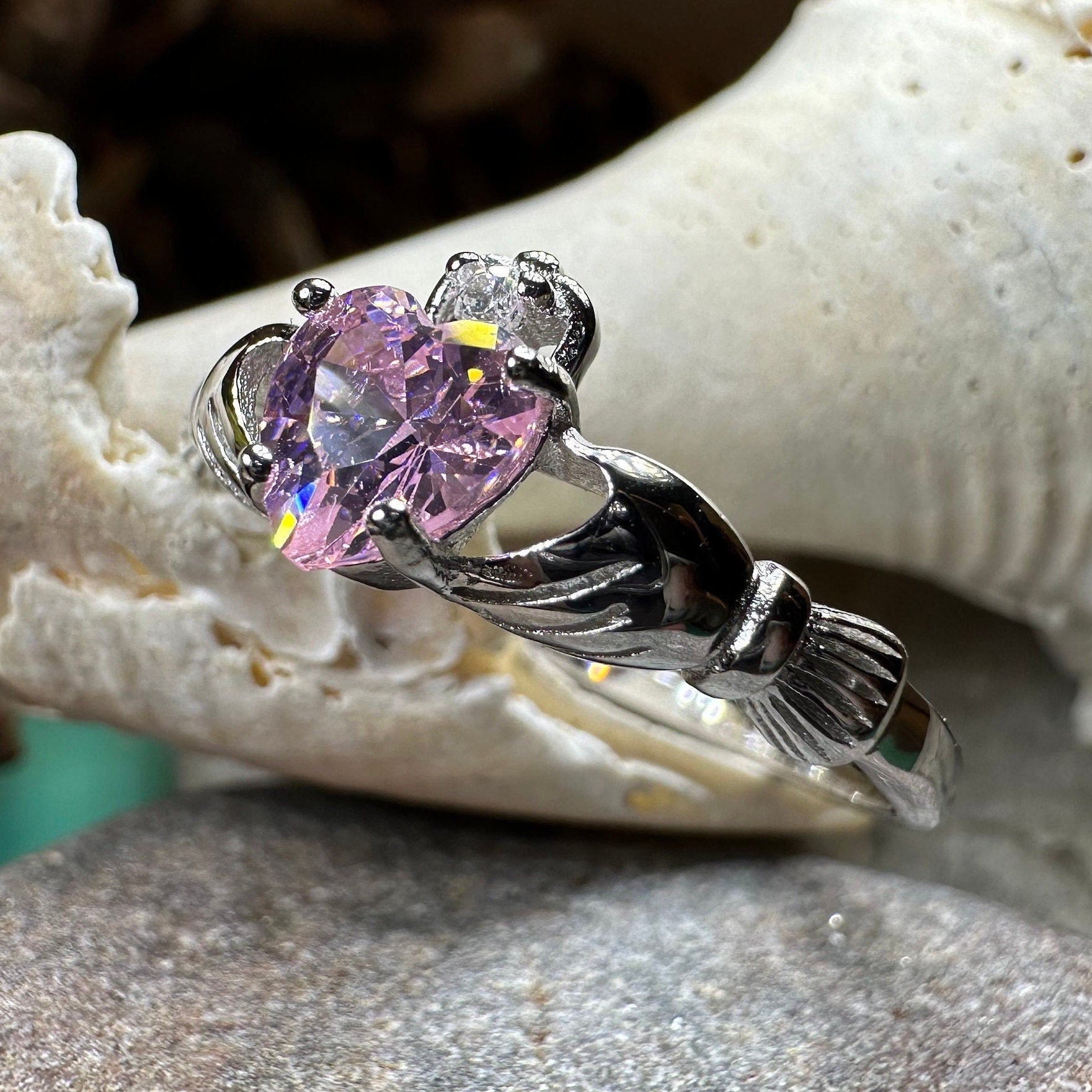 Light pink Petal Claddagh Ring by Celtic Crystal Design Jewelry featuring intricate Celtic detailing and a delicate pink gemstone.