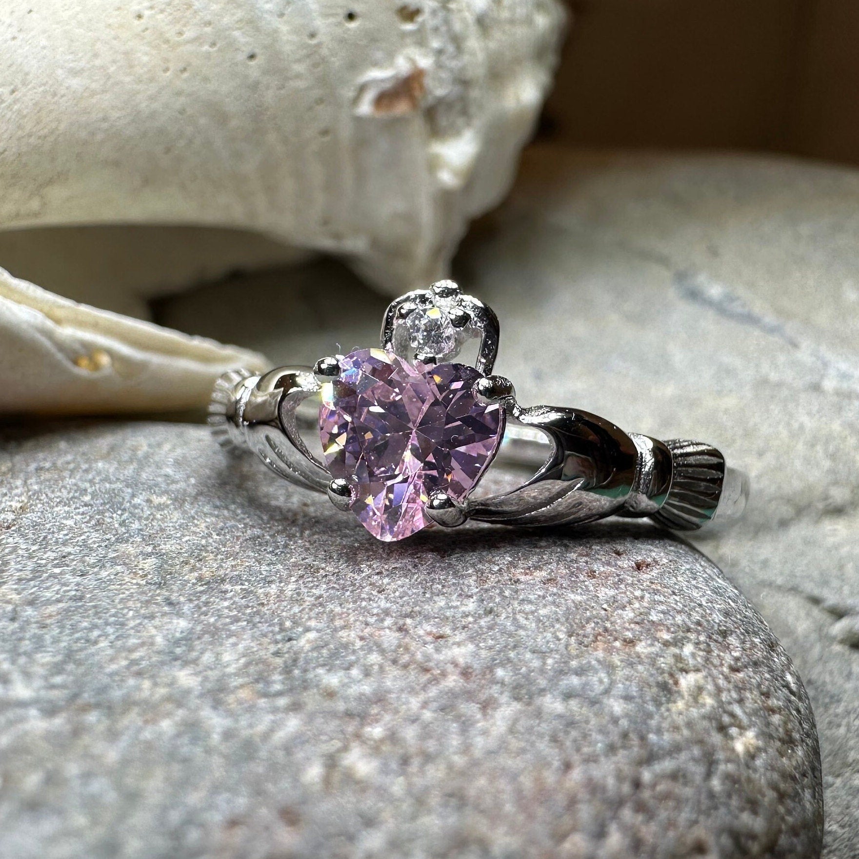 Petal pink Claddagh ring by Celtic Crystal Design Jewelry featuring a delicate heart and crown design in light pink.