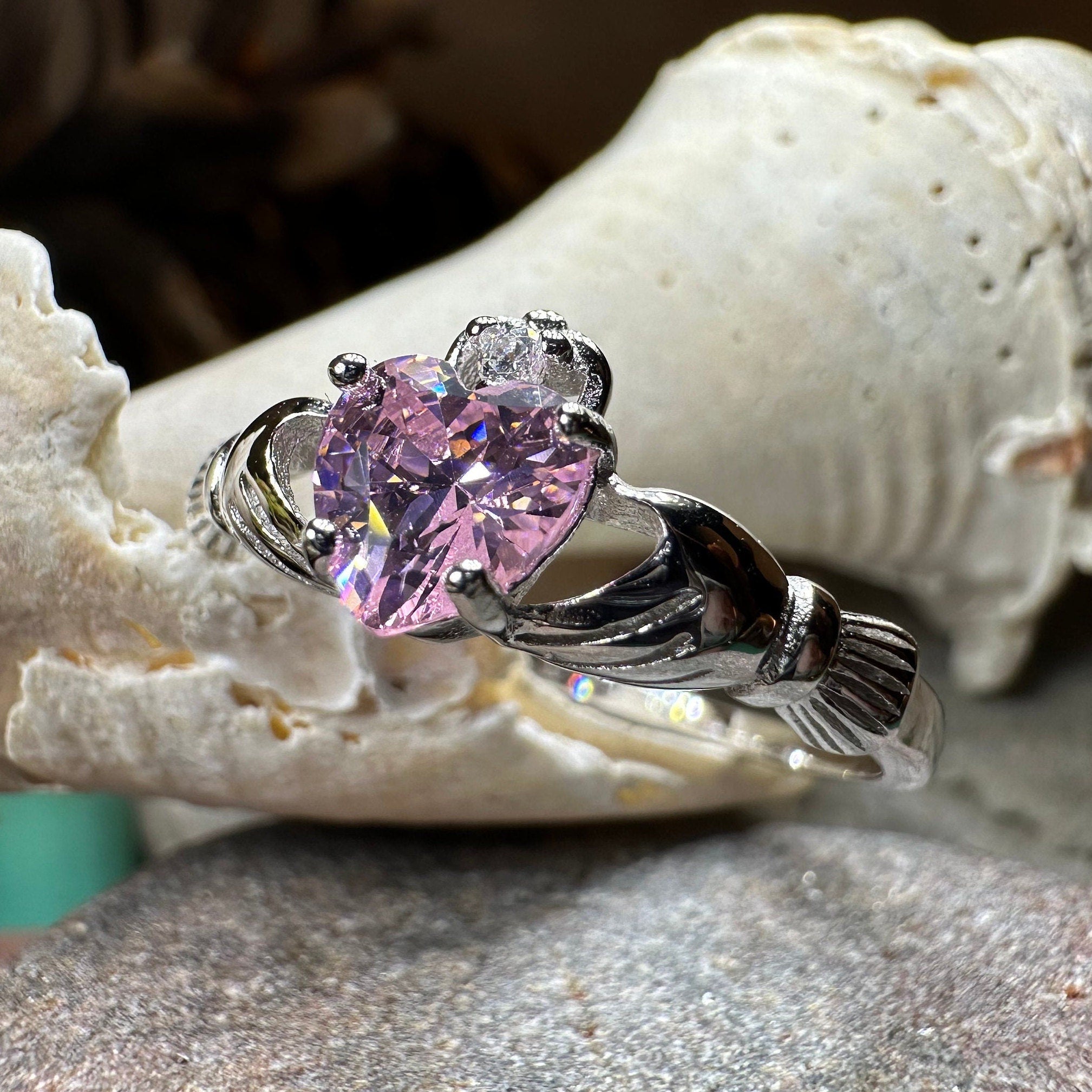 Petal pink Claddagh ring by Celtic Crystal Design Jewelry, featuring intricate Celtic motifs and a delicate pink gemstone.