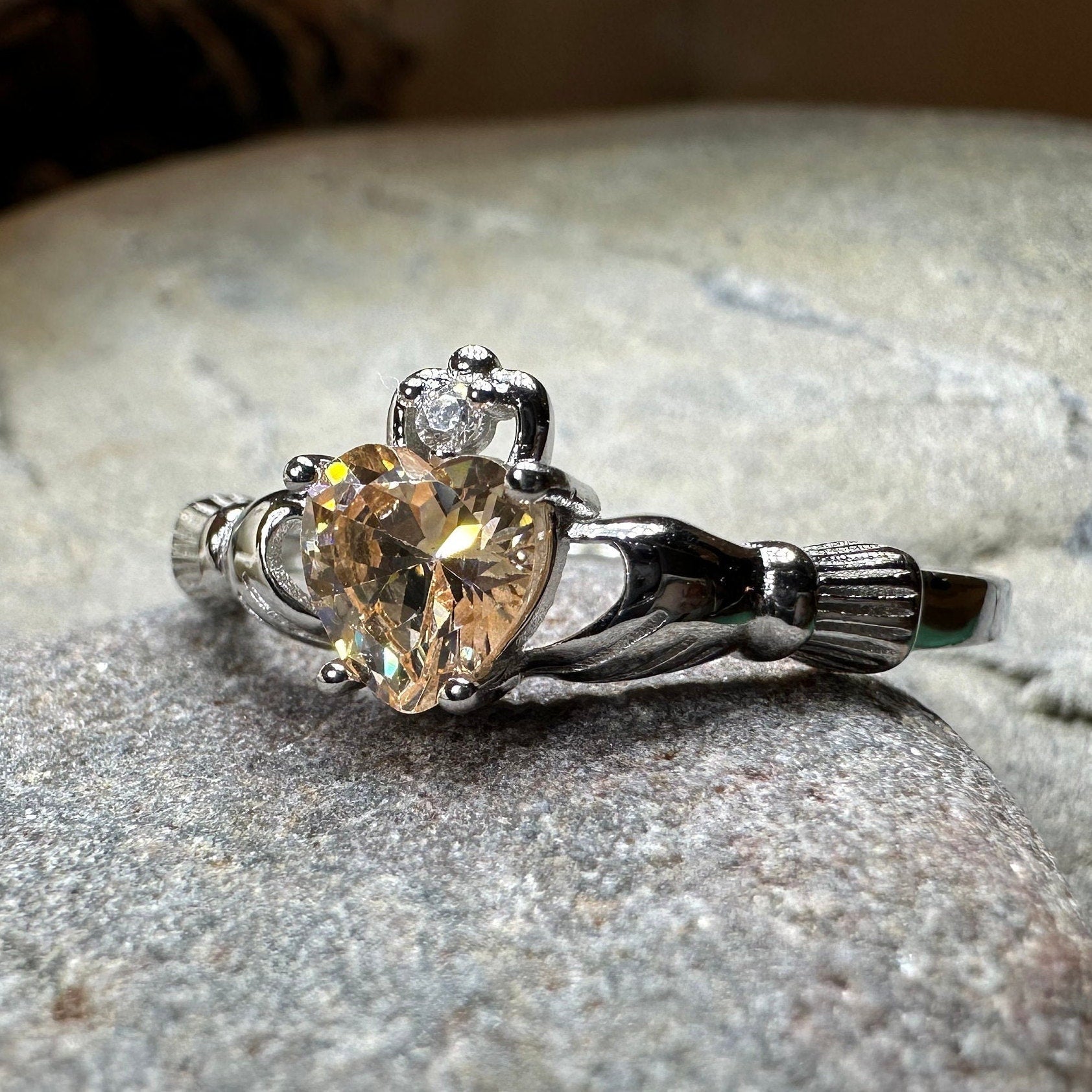 Champagne Toast Claddagh ring by Celtic Crystal Design Jewelry featuring a gold-tone band and intricate Celtic knot details.