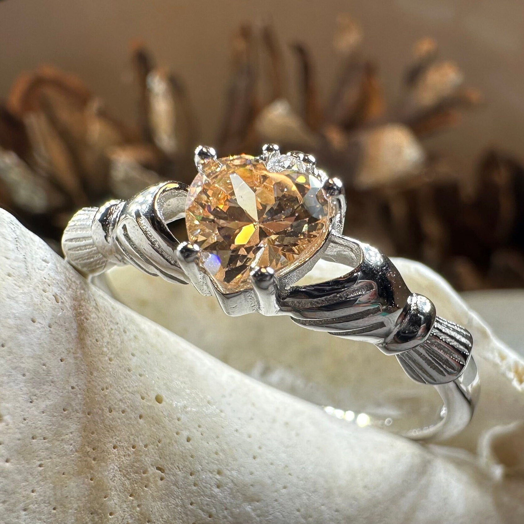 Celtic Crystal Design Jewelry Champagne Toast Claddagh Ring featuring a detailed Celtic pattern and sparkling champagne-colored crystals.