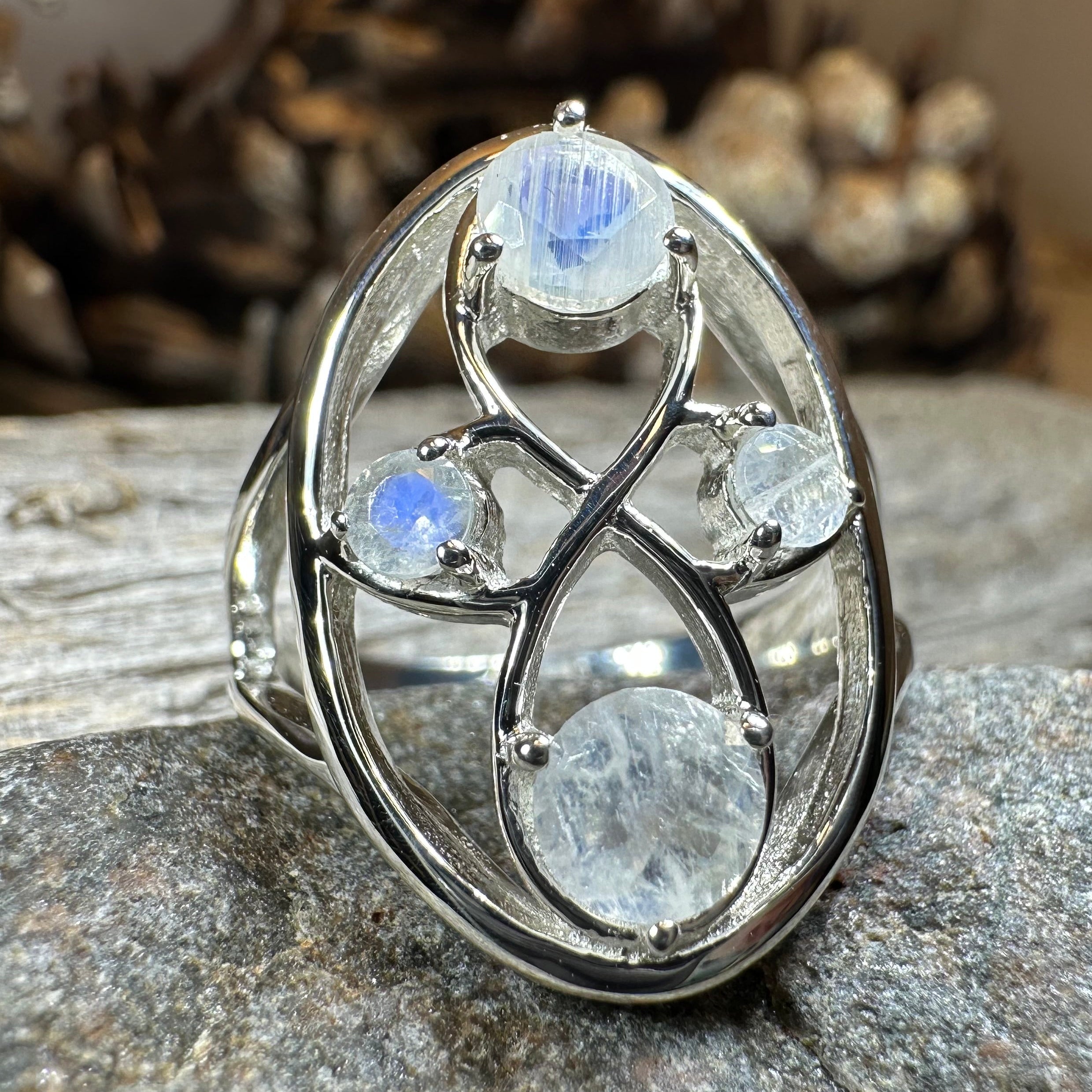 Celtic Crystal Design Jewelry moonstone infinity ring with intricate Celtic pattern and shimmering moonstone centerpiece.