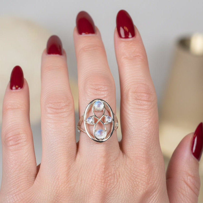 Celtic Crystal Design Jewelry moonstone infinity ring featuring a polished moonstone gemstone and intricate Celtic-inspired band design.