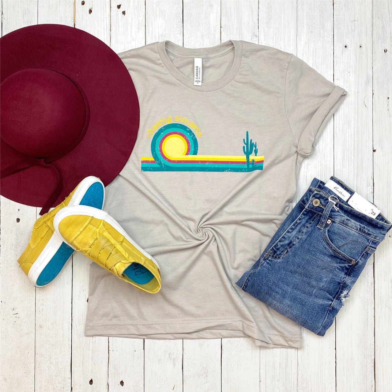 The Graphic Tee chasing Sunsets Retro SS Graphic Tee featuring a vintage sunset design on a casual short-sleeve shirt.