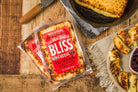Golden Baked Bliss Cheese from Cheese Brothers, Inc., showing a freshly baked cheese block with a golden crust and melty interior.