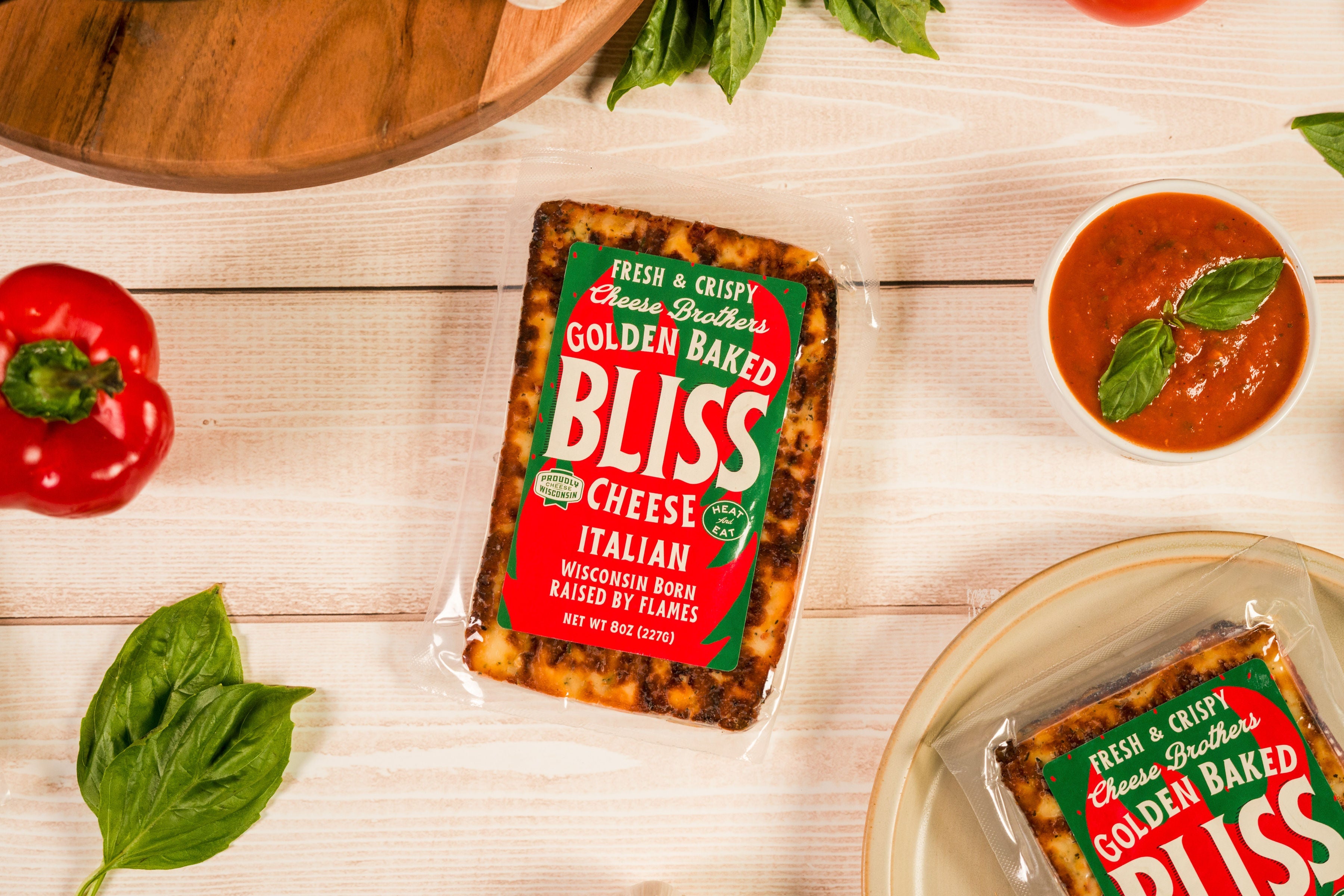 Italian Golden Baked Bliss Cheese by Cheese Brothers, Inc., showing melted baked cheese with a golden crust and creamy interior.