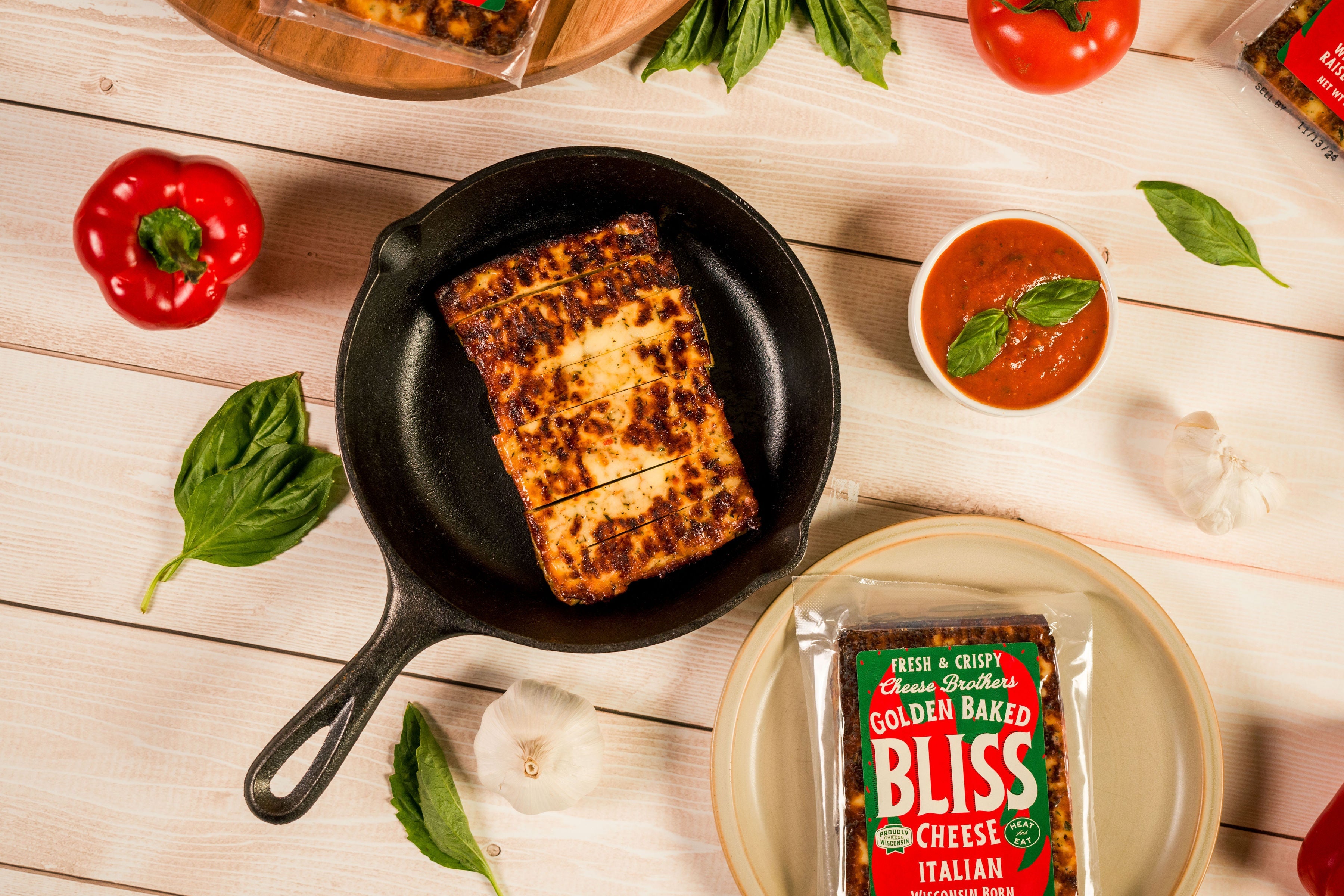 Italian Golden Baked Bliss Cheese from Cheese Brothers, Inc., showing melted baked cheese with a golden crust and rich texture.