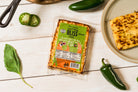 Golden baked cheese snack with jalapeño peppers from Cheese Brothers, Inc., showcasing a crispy, cheesy treat with spicy jalapeño slices.