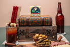 Slices of Precious Cargo Horseradish Cheddar cheese from Cheese Brothers, Inc. displayed on a wooden board with crackers
